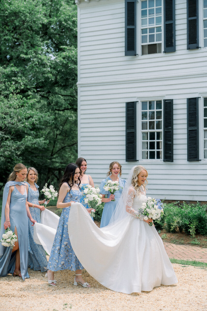 Bride in robe holding champagne while getting ready for her Williamsburg wedding, planned by Sweet Caroline Events. Photo by Marshall Arts Photography.