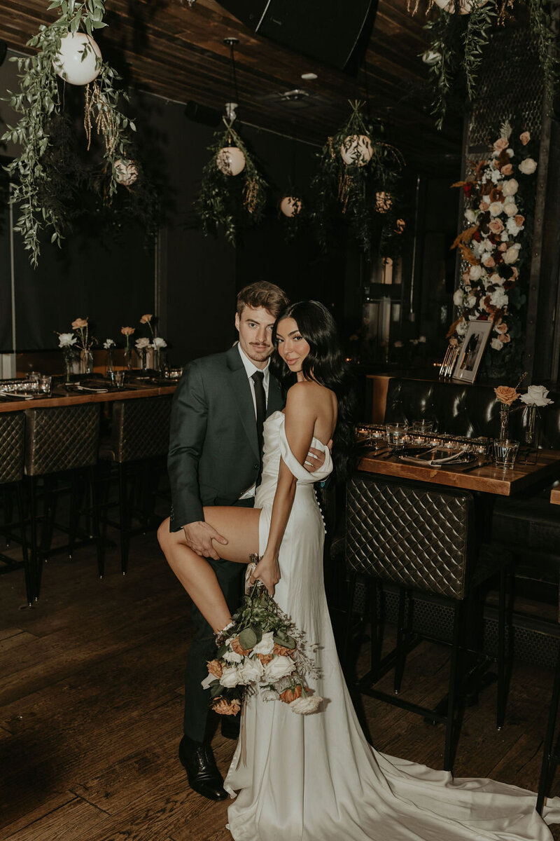 bride and groom posing for camera