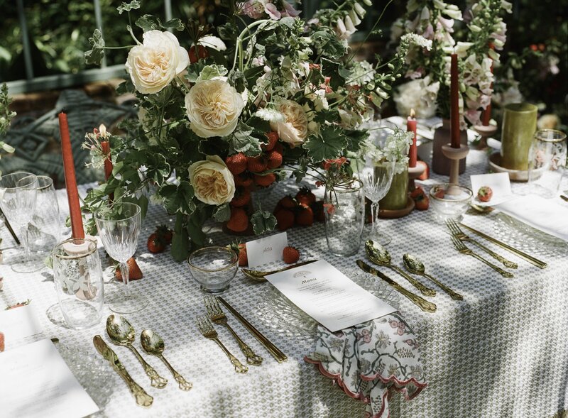 Garden party outdoor reception table with illustrated menus and strawberries with wedding florals by Good Seed Floral photographed by Taylor Friedman Photo