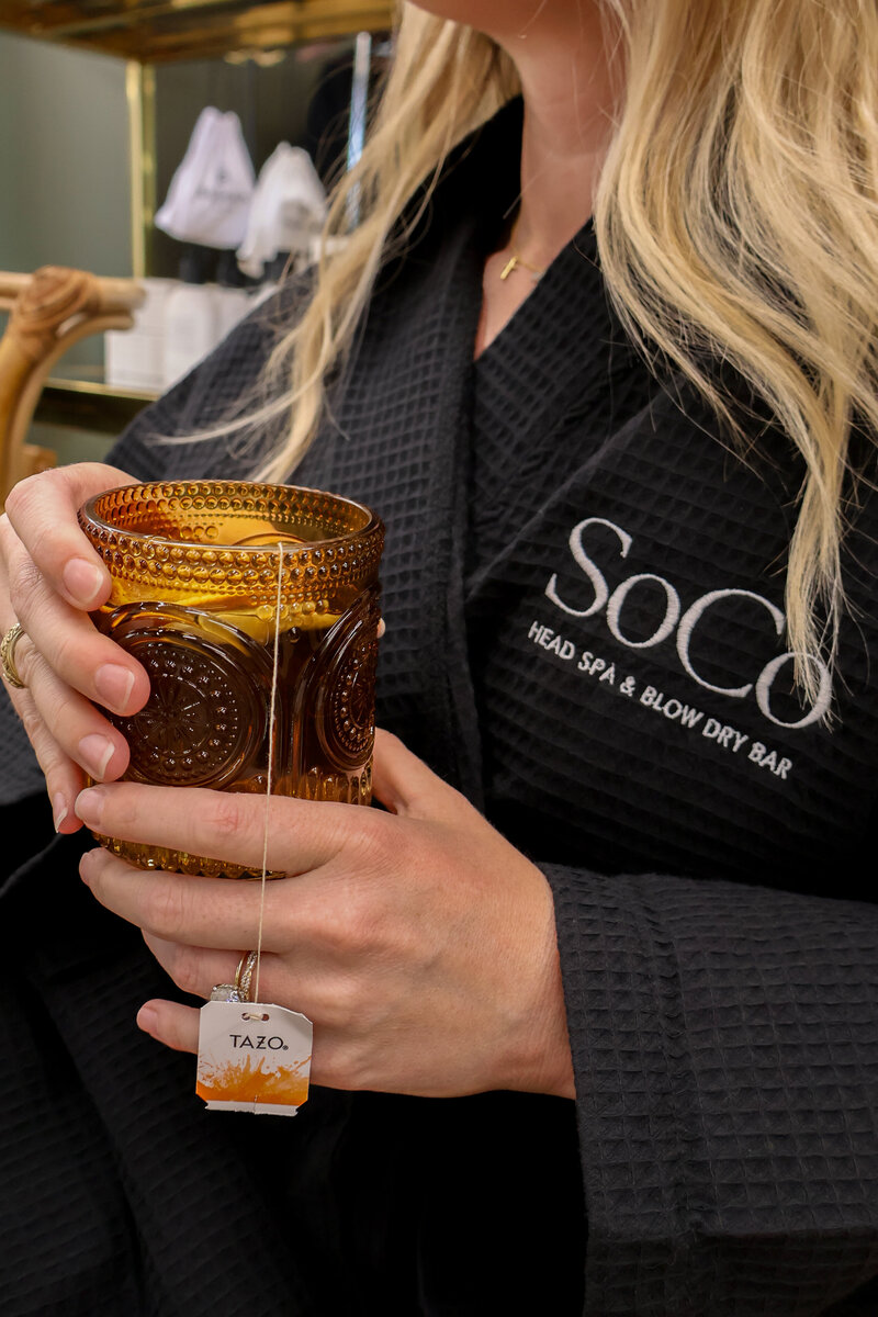 Herbal tea served after a scalp facial to complete the luxury wellness experience.