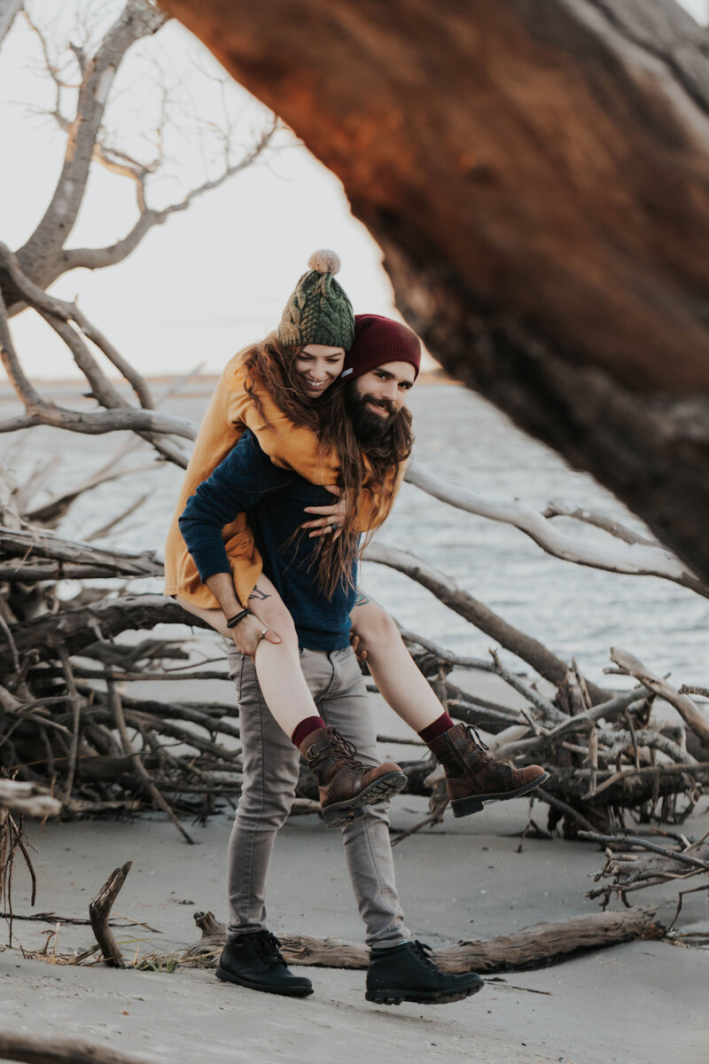 couple piggy back on beach