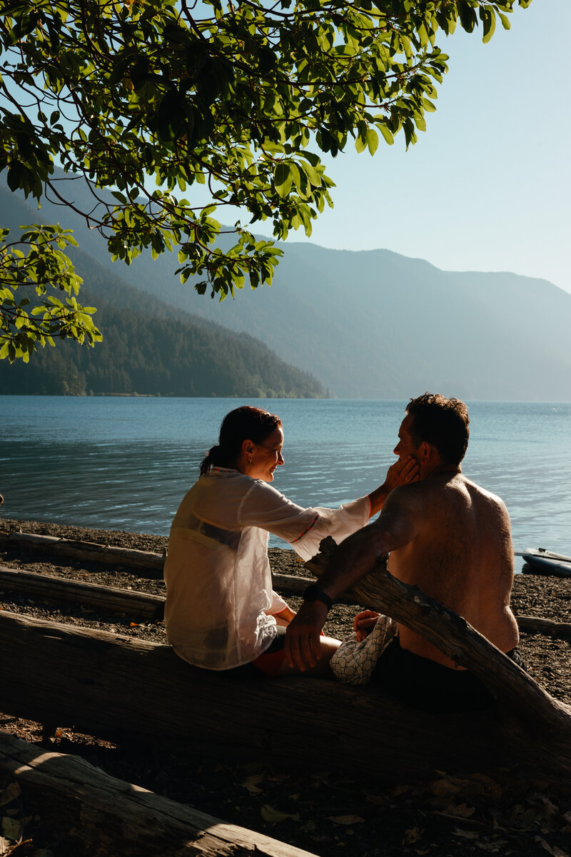 Couple enjoying a romantic picnic in a sunlit park, surrounded by nature