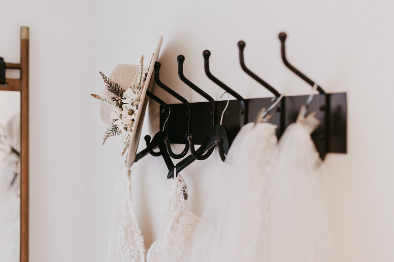 Wall hooks for clothes and stuff in the bridal suite. They are black, the clothes are white.