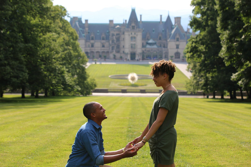Light Shifter Studios Photographs a couple getting engaged at the top of the lawn at the Biltmore Estate. 
