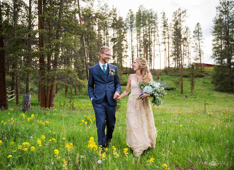 Wedding couple with yellow wildflowers at B Lazy 2 Ranch