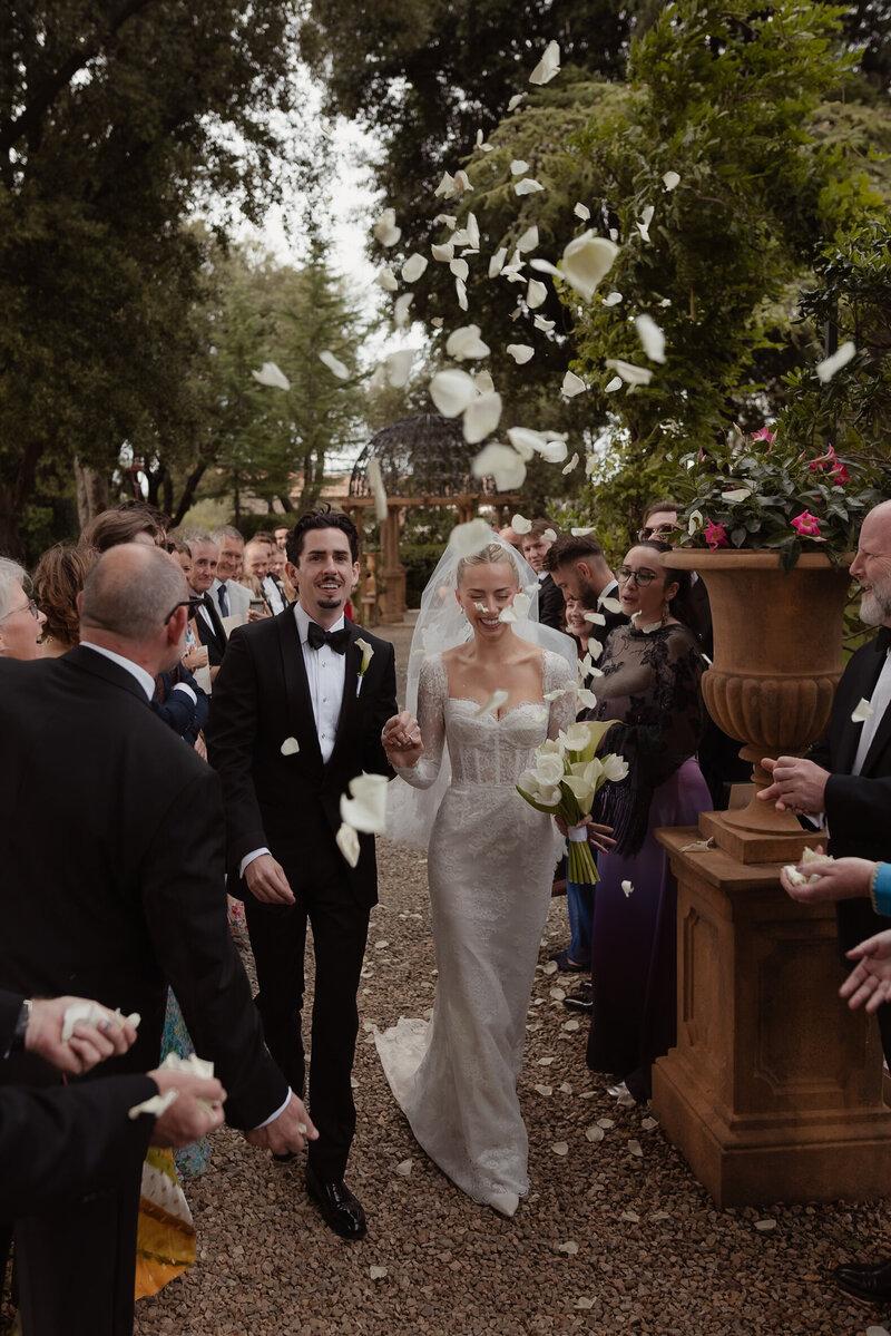 A portrait view of Janice and Bertie embracing at a garden wedding ceremony in the Cotswolds