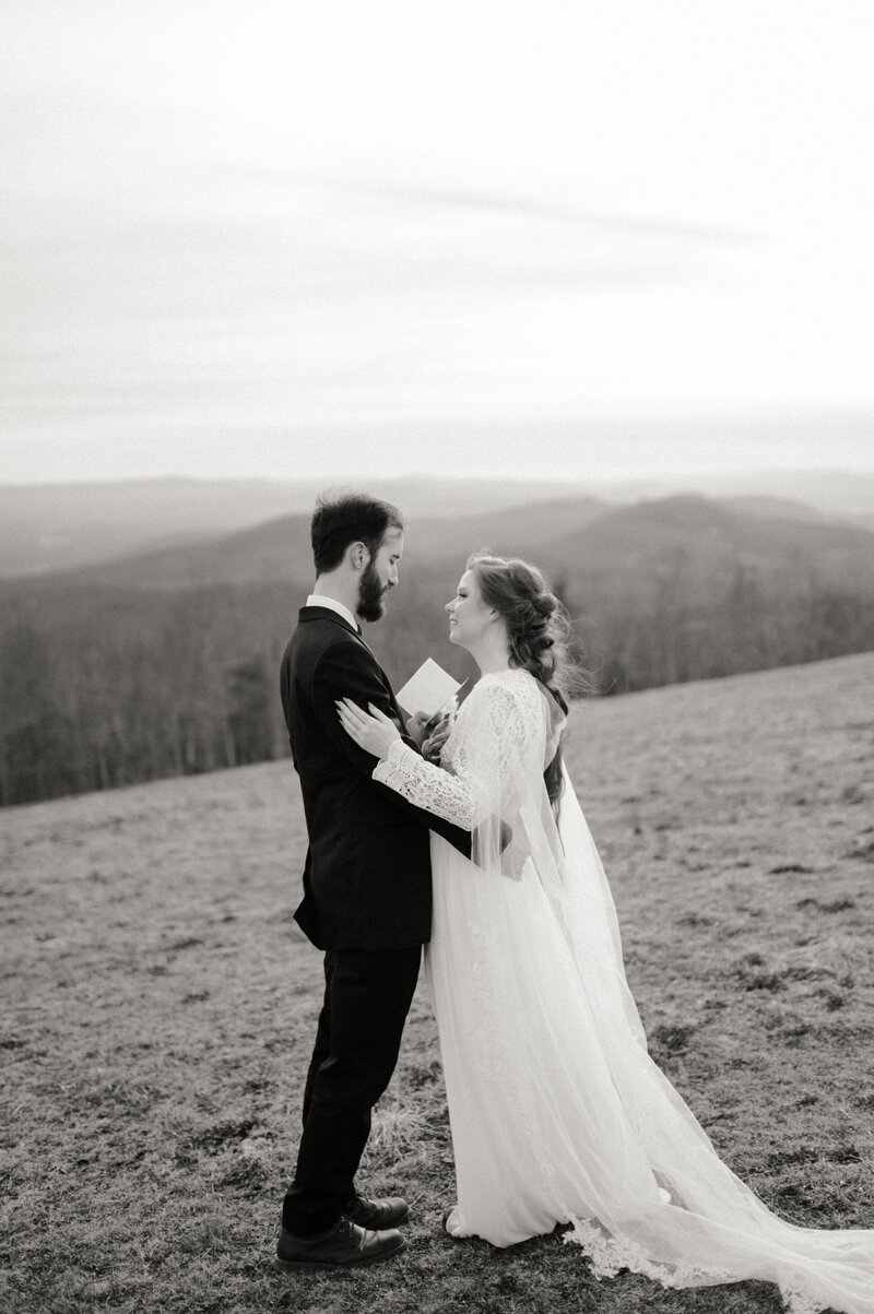 Bride and groom reading vows to each other during Asheville, NC mountain elopement
