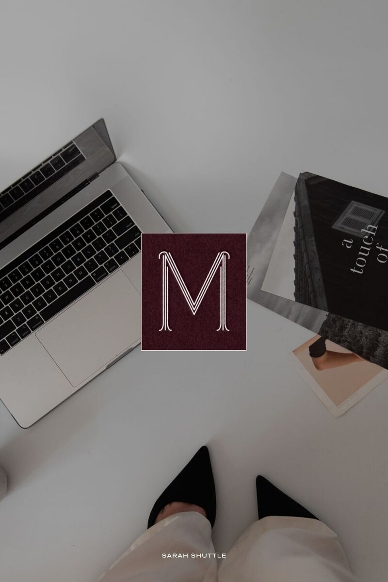 Submark logo for The Maddison Edit over an editorial photo of books and shoes, blending lifestyle elegance with luxury branding.