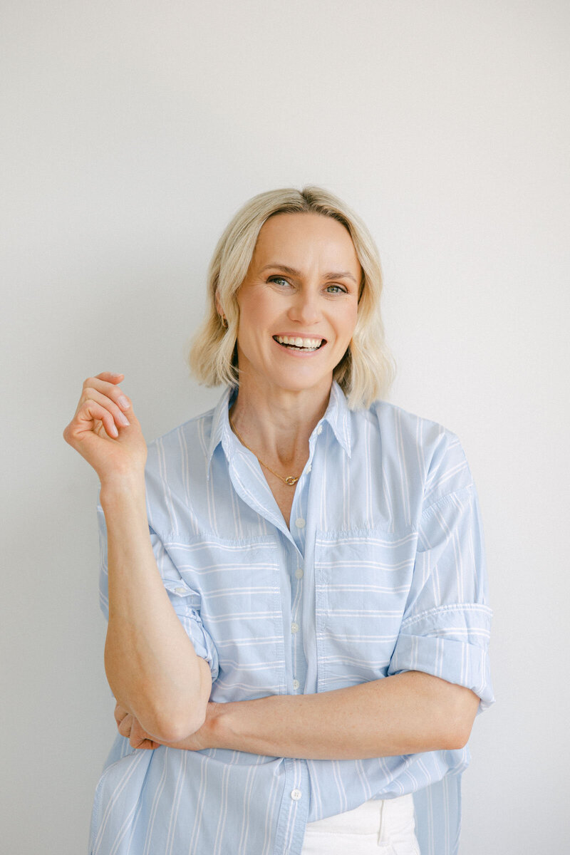Zelda Green, professional photographer and educator, smiling in a light blue shirt