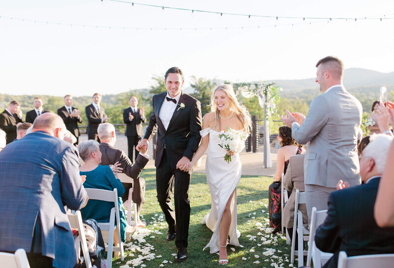 Bride and Groom walking down the isle during the recessional at Blue Valley Vineyard in Deleplane, Virginia. Taken by Charlottesville Wedding Photographer Bethany Aubre Photography.