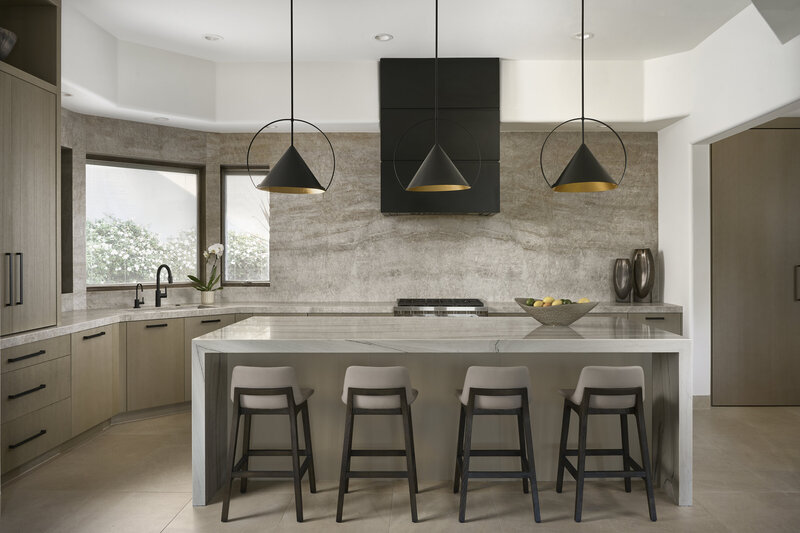 JSF Design kitchen with a statement metal hood and natural quartzite stone backsplash