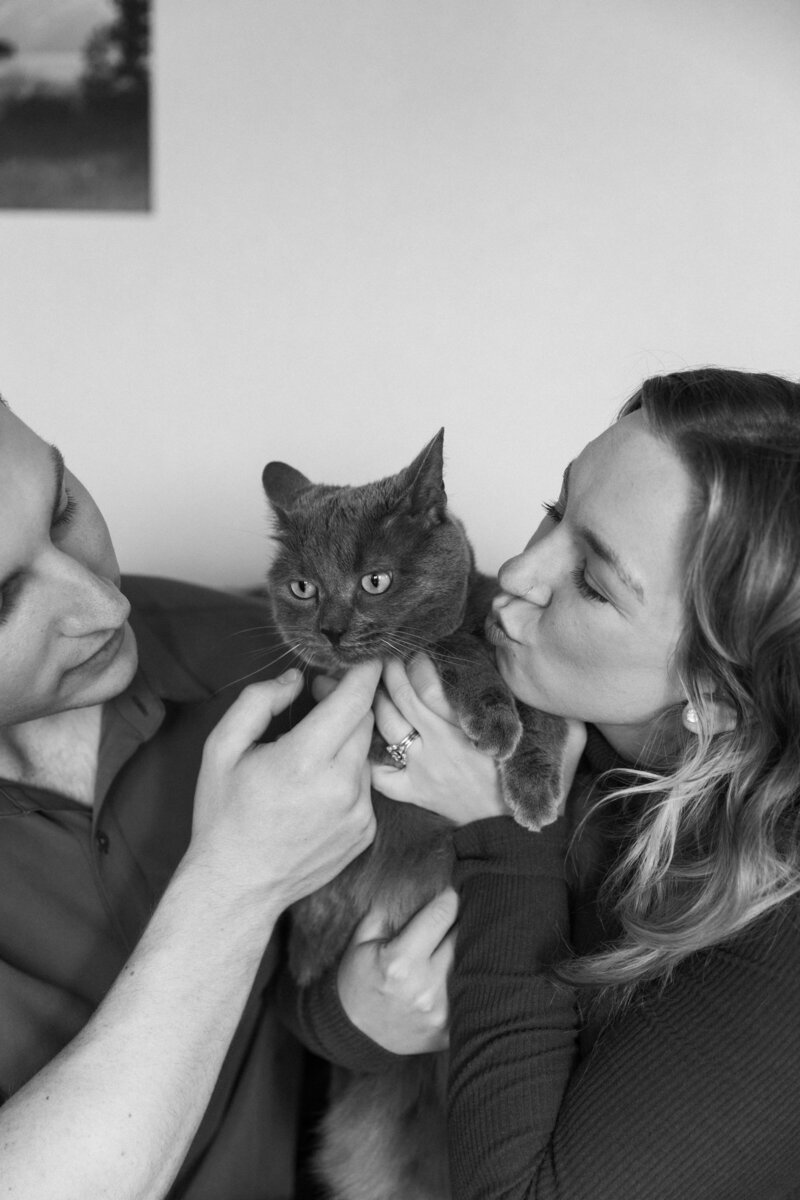 Logan Ferree kissing her cat with her husband during her lifestyle brand photos