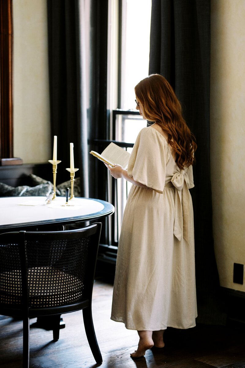 monica standing with open book