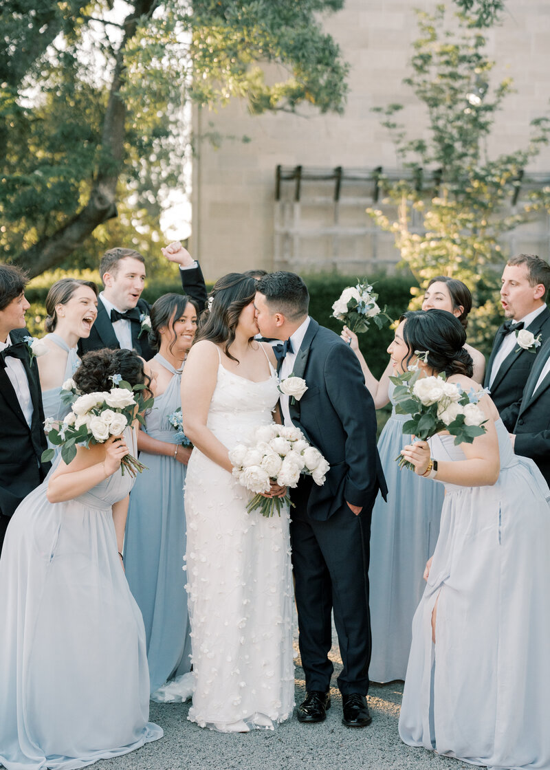 Bride and groom smiling holding each other tightly.