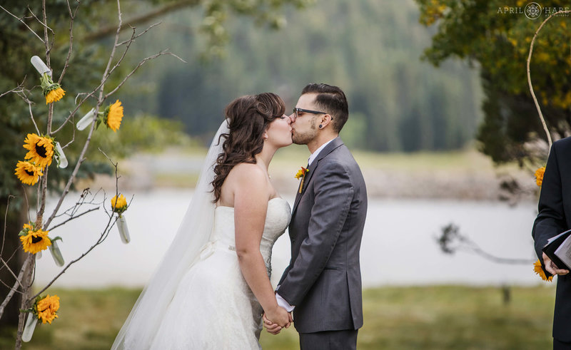 Ceremony kiss on the lawn at Barn at Evergreen memorial park