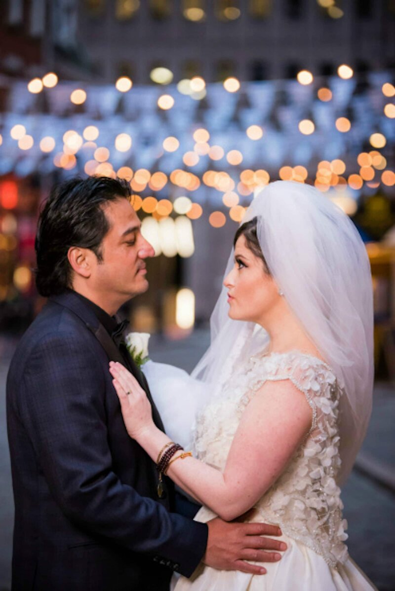 Bride and groom under twinkle lights
