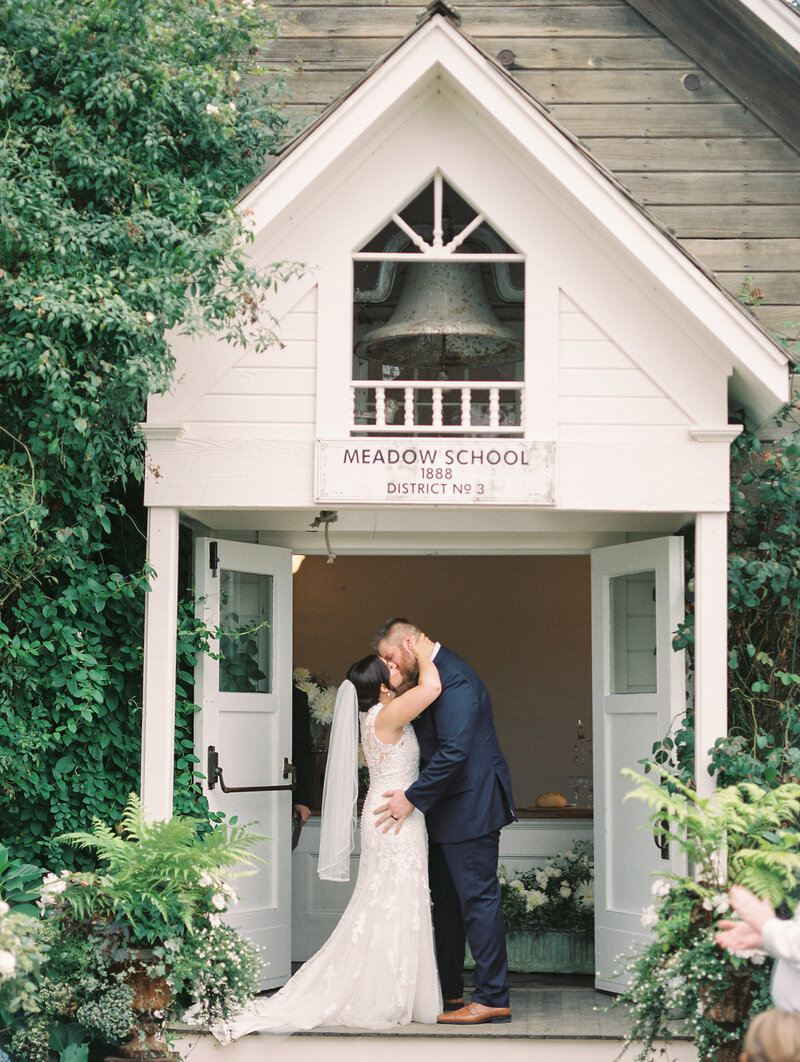 bride and groom kiss during wedding ceremony