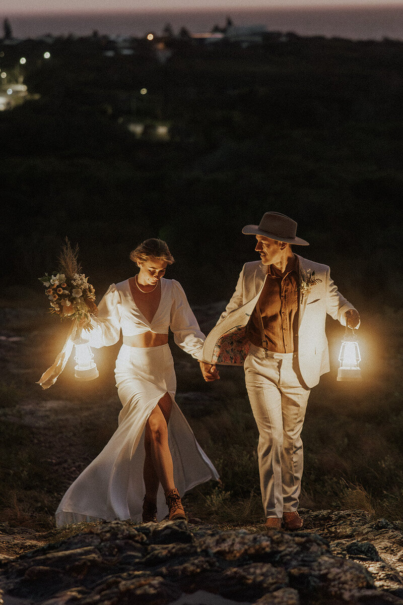 Adventure elopement captured at night on the Sunshine Coast, with a couple walking under lantern light.