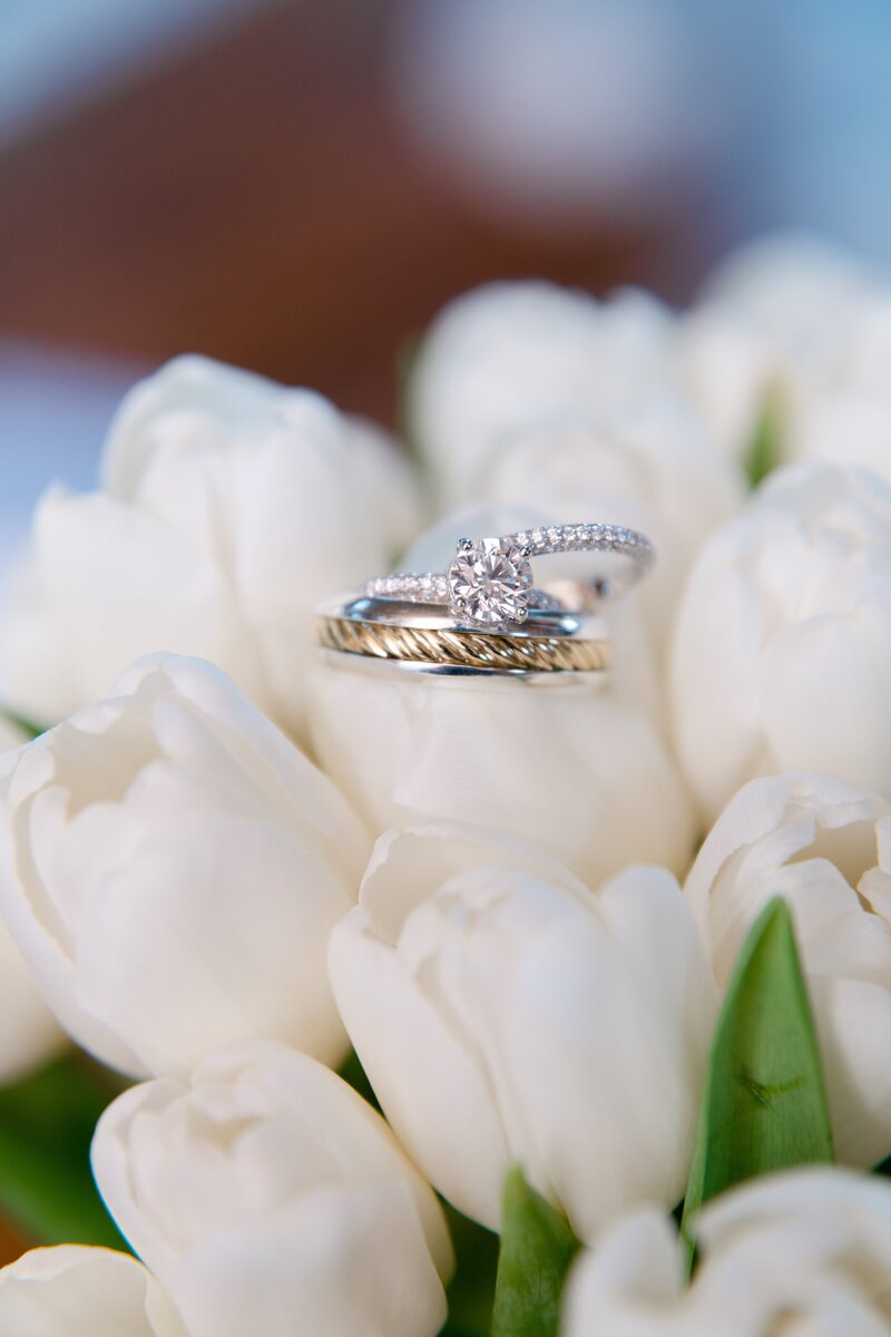 wedding ring photos with rings sitting on top of wedding shoes in texas
