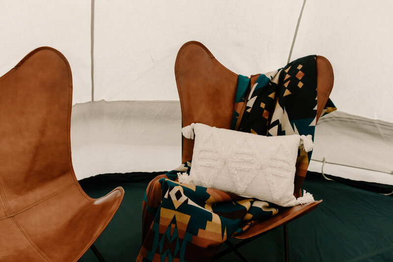 Leather Butterfly Chairs with Pendleton Blanket and cream throw pillow