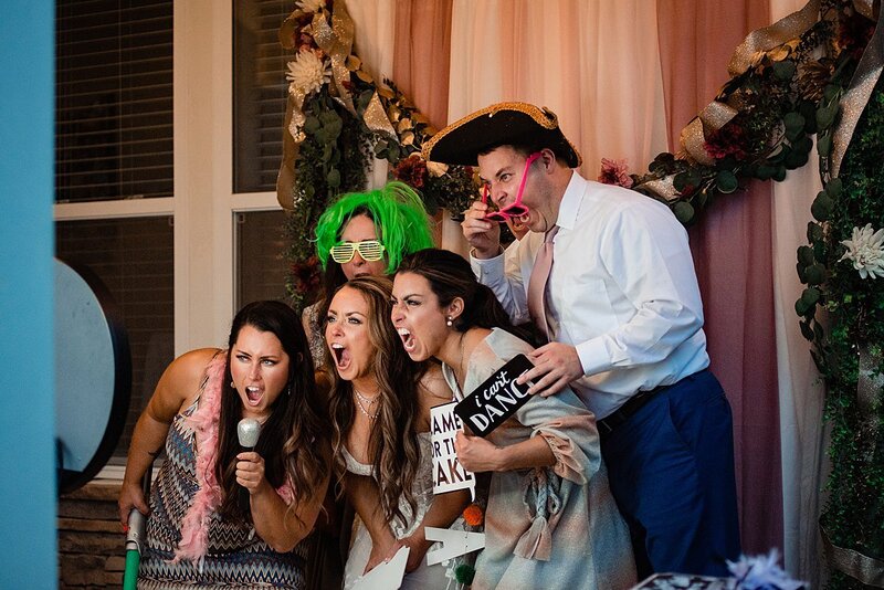 Bride with her family making funny faces for a gif in the photobooth