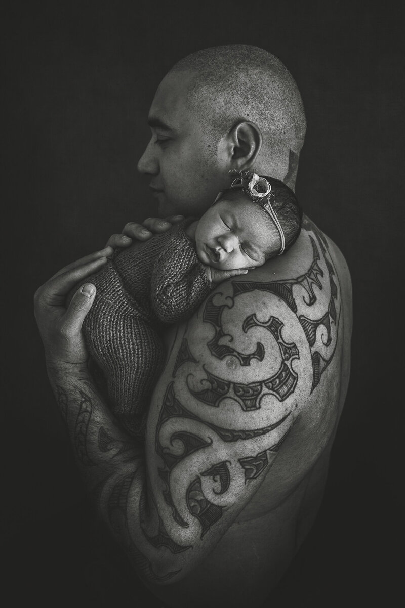 tattooed dad holding baby girl