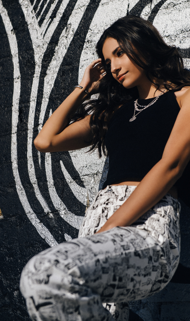 Sophie's senior session in ventura brunette girl leaning on grafitti wall