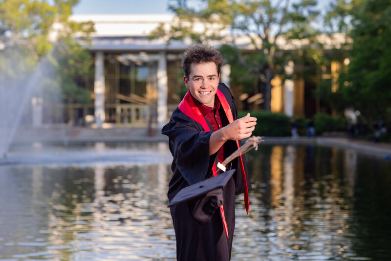 A University of South Carolina student posing for her senior portrait on campus at the historic horseshoe