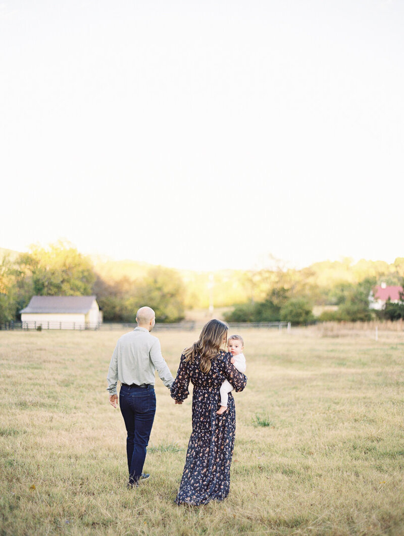 Mother laughs and holds belly during her maternity session by Nashville Photographer Grace Paul