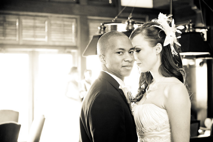 Bride and groom embrace in black and white