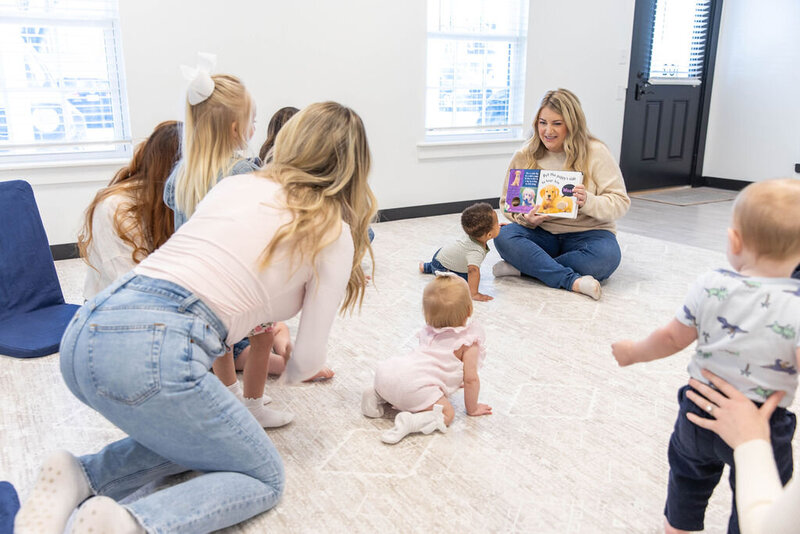 Woman reading a book to babies