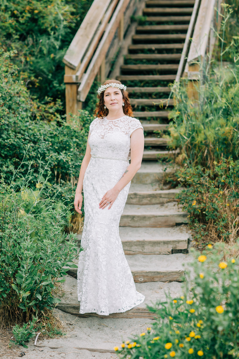bride stand by stairs at beach