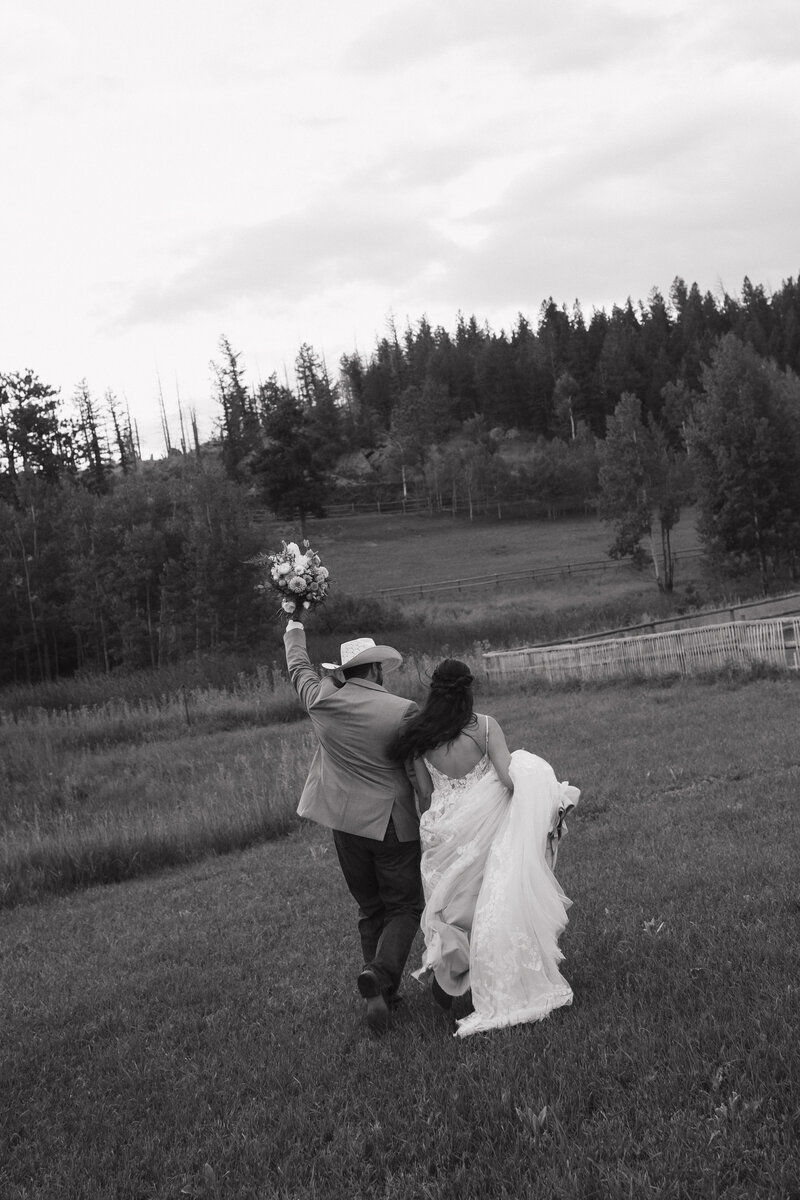 Photo of bride twirling in her wedding dress while smiling taken by Va ail ski resort wedding photographer