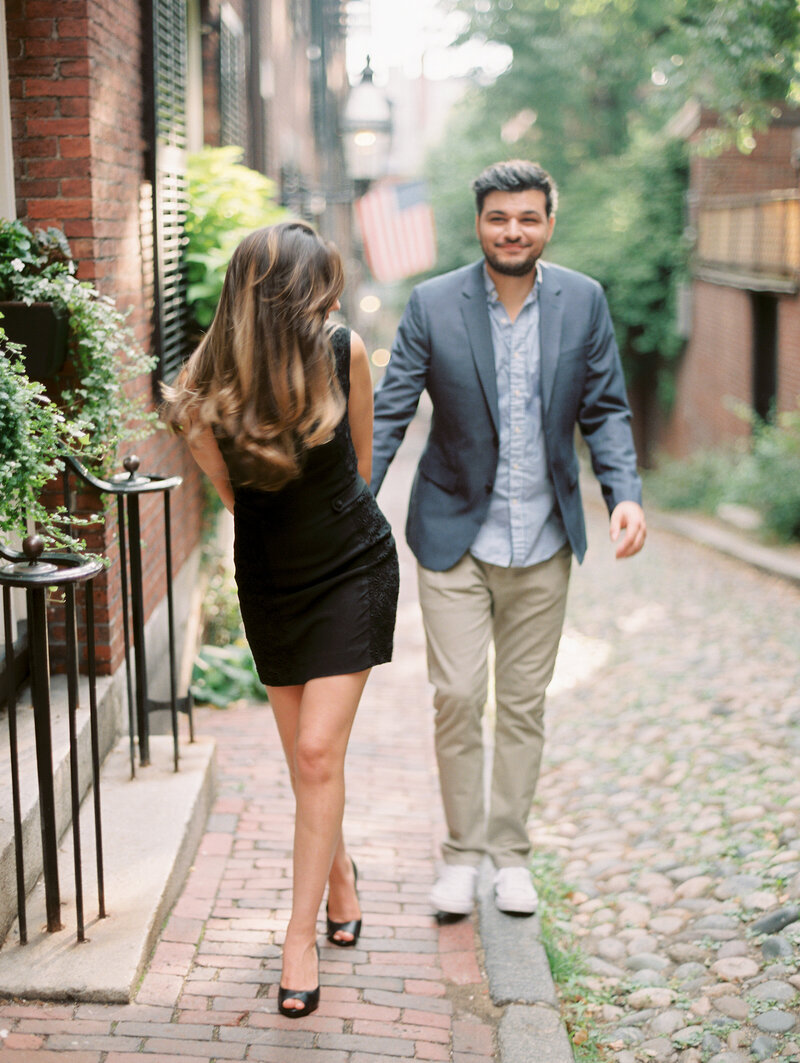 Bride and groom walk on cobblestone street in Boston