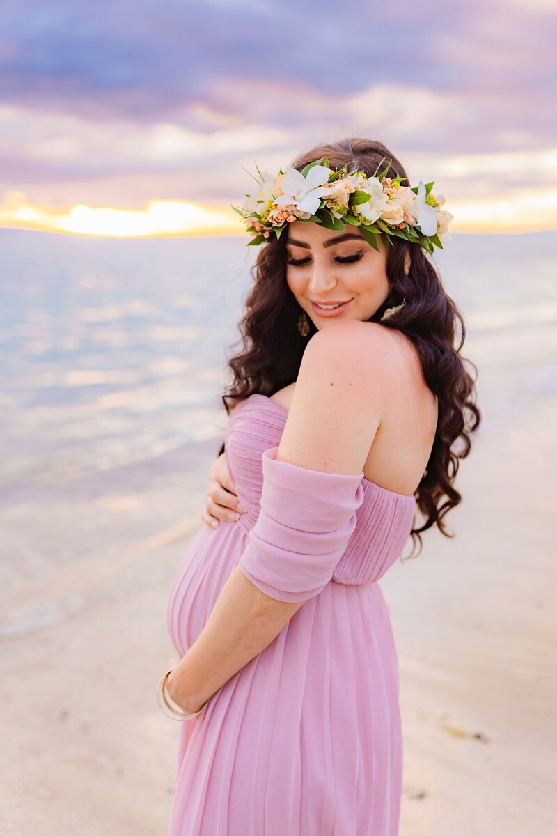 gorgeous floral crown worn by woman in violet maternity gown for babymoon photoshoot in west maui