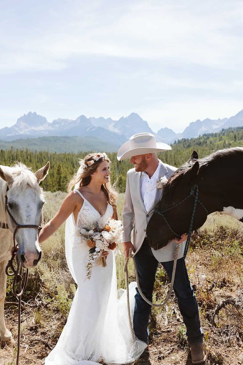 A couple looking into each others eyes laughing in the Sawtooth mountains in Stanley, Idaho