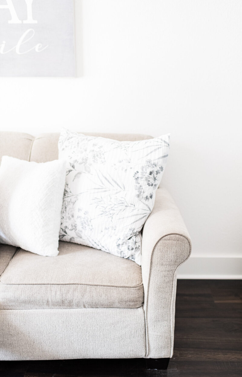 Beige couch with white pillows