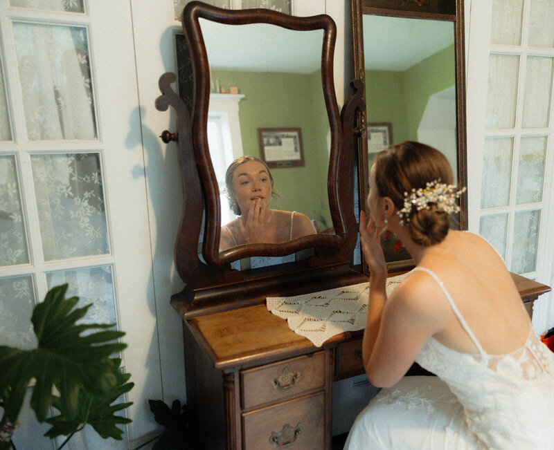 vermont bride getting ready in mirror