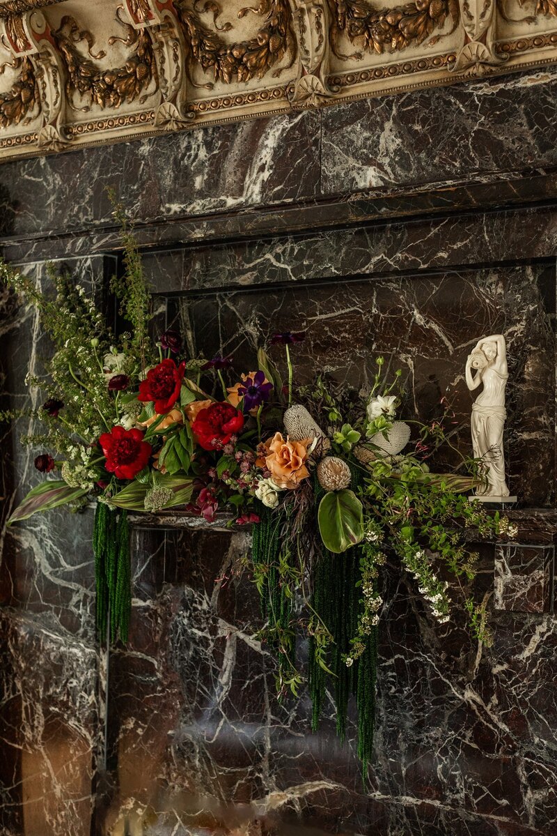 Elegant floral arrangements featuring white orchids, blush roses, and hydrangeas adorn a table at a Four Seasons Chicago wedding, showcasing the expertise of Chicago wedding planner Savoir Fête.