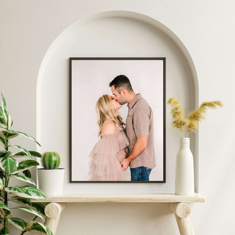 framed maternity photo of couple kissing in Springfield MO family photographer studio