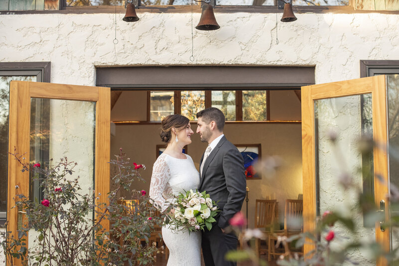 Couple standing roses Asheville, NC tiny chapel wedding