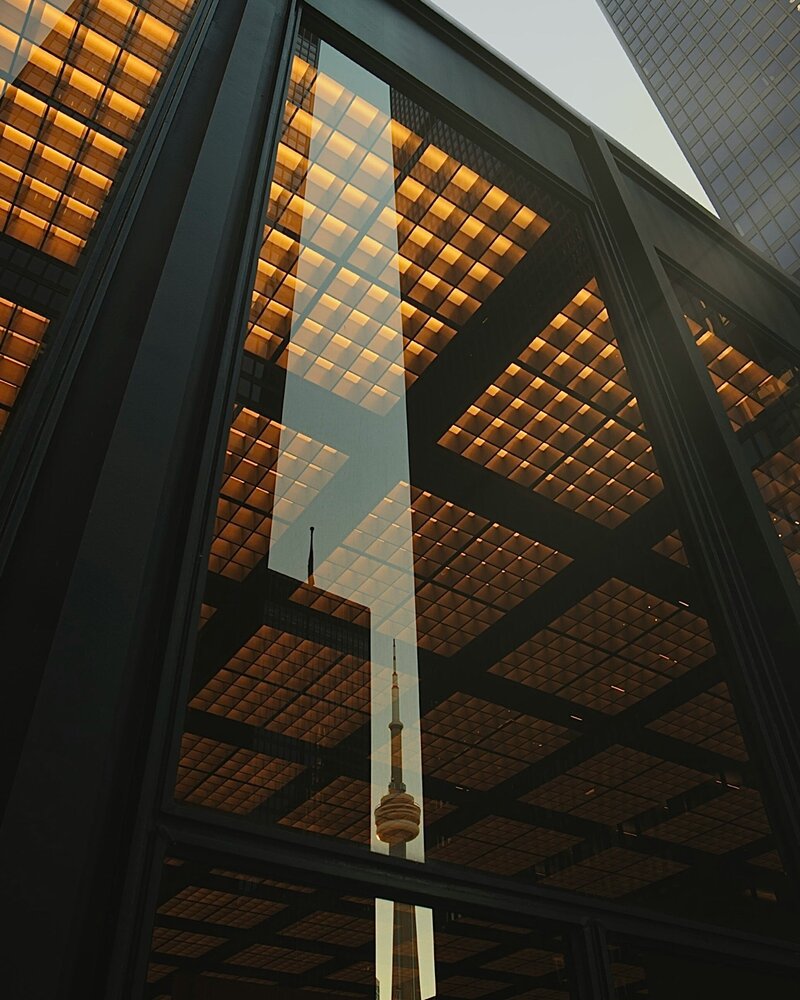 building window with the CN tower in its reflection