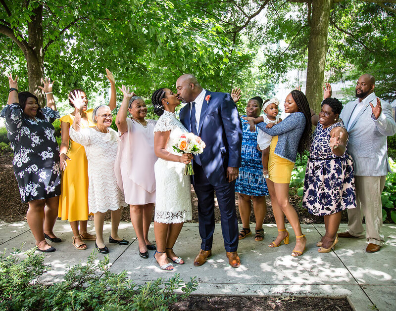 small wedding photography- Family throwing hands up in celebration
