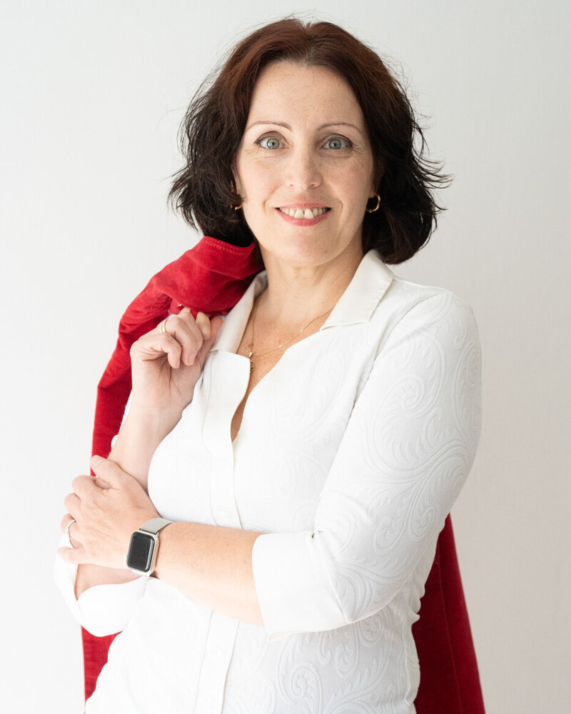 Csilla with a slight smile, half portrait.