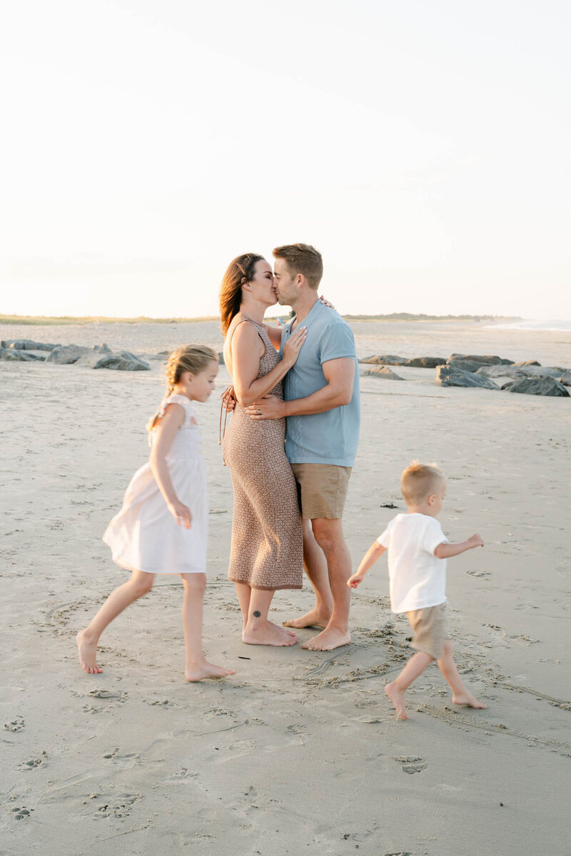 family of five plays during a photo session with AnneMarie Hamant