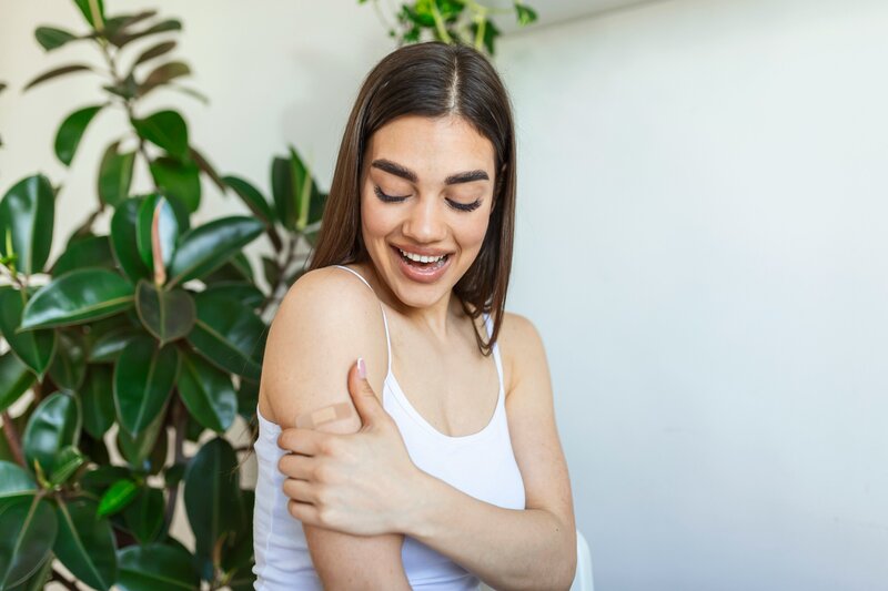 Woman with bandaid on her arm