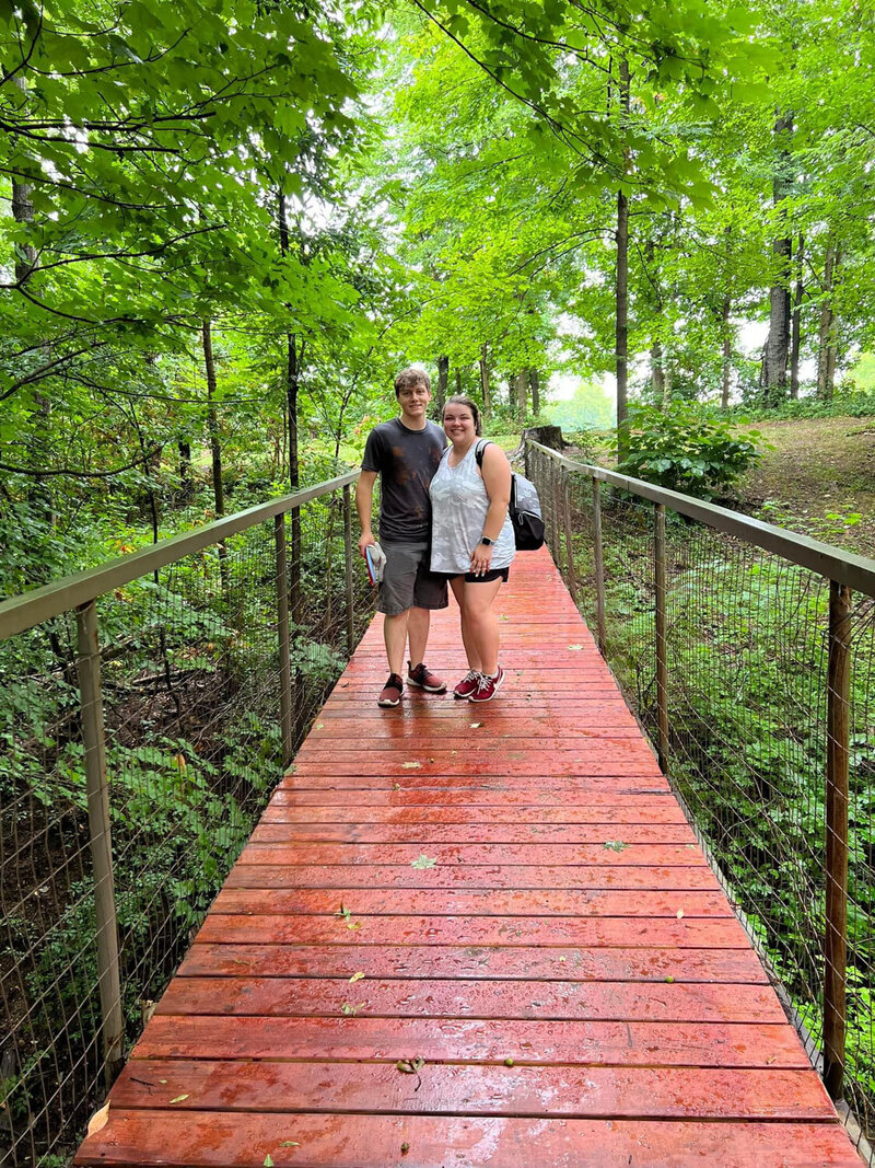 Couple standing beside the creek
