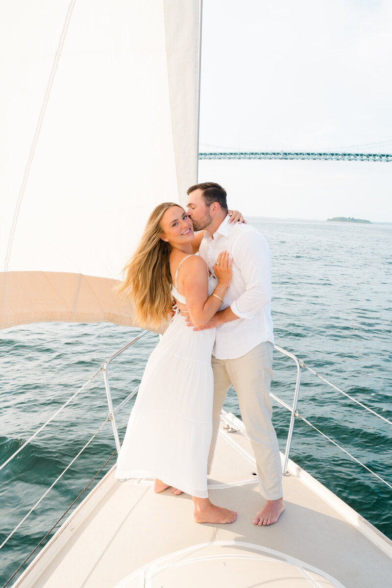 Newport Wedding Photographer | Rhode Island Caprio Captured Photography | Couple embracing at a sailboat enagement session in Newport, RI by Newport wedding photographer Alicia Caprio