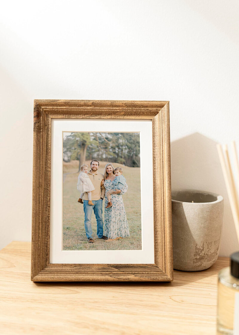 Family photo in frame on table.