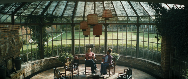 A portrait shot of the lead character looking into a mirror, rich in color and detail.